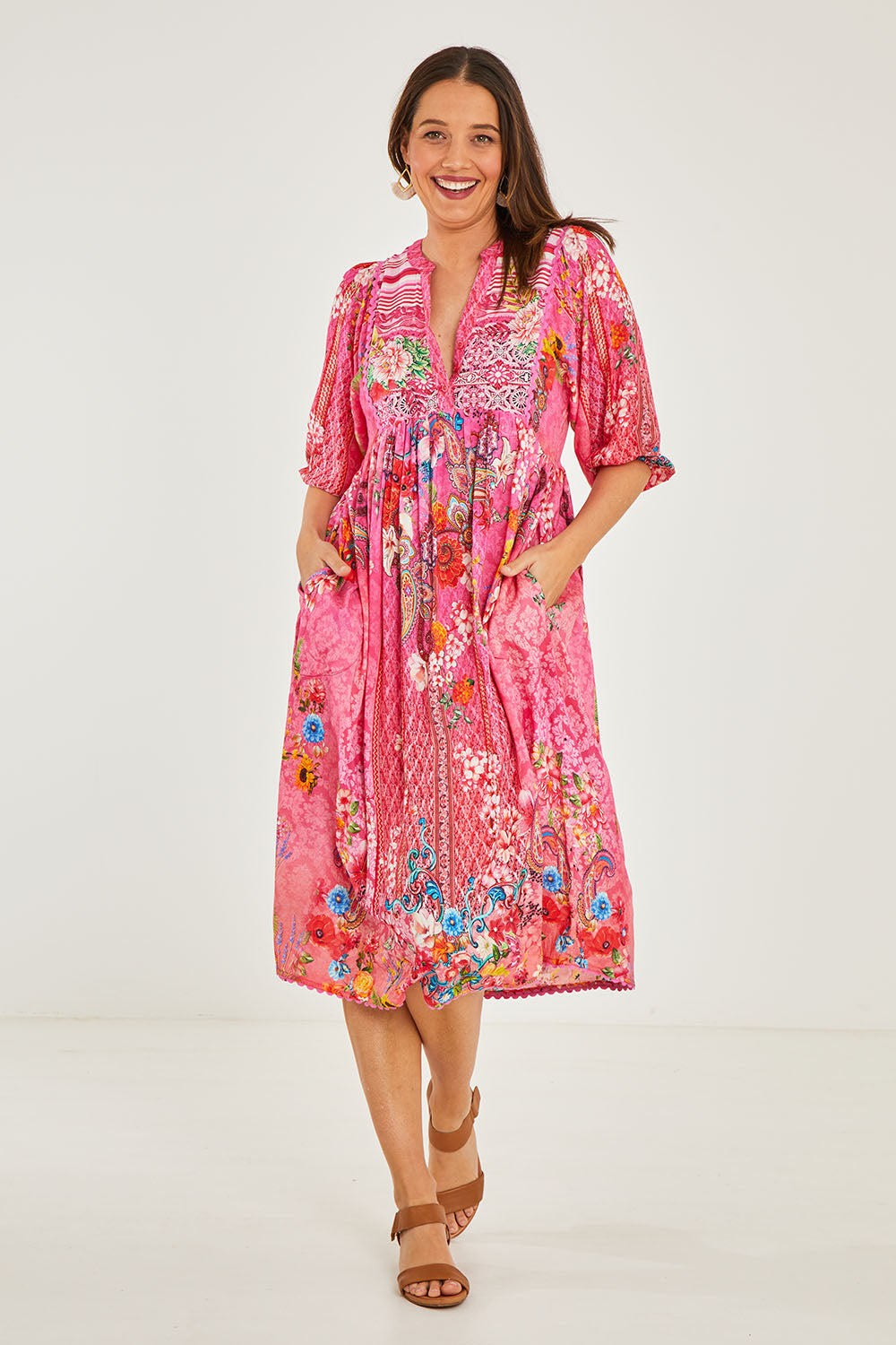 Model Georgia wearing size S of the Frankie Midi Dress in colour Melon (Pink), from the front, showing the whole outfit