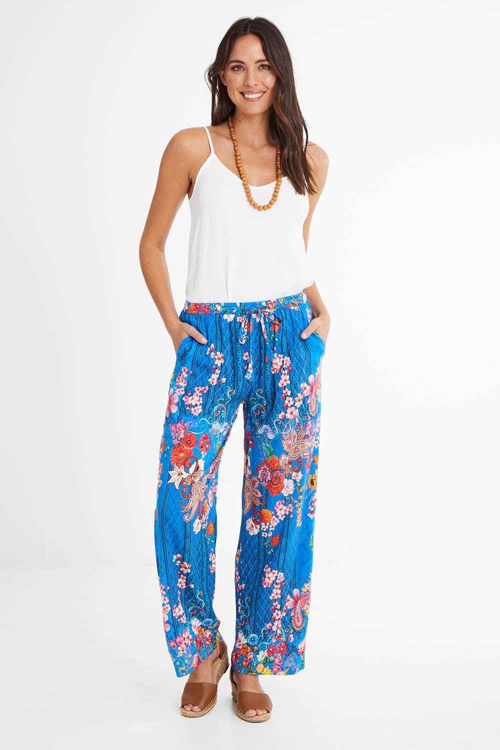 Model Madeline wearing size S of the Frankie Pant in colour Ocean (Blue), from the front, showing the whole outfit