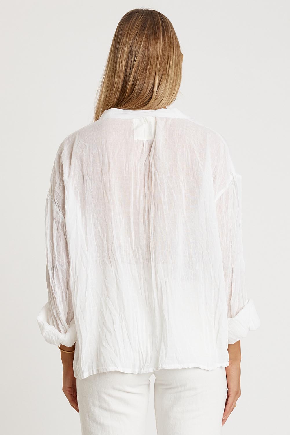 A model wearing the Keziah Cotton Shirt in colour White (White), from the back