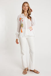A model wearing the Keziah Cotton Shirt in colour White (White), from the front, showing the whole outfit