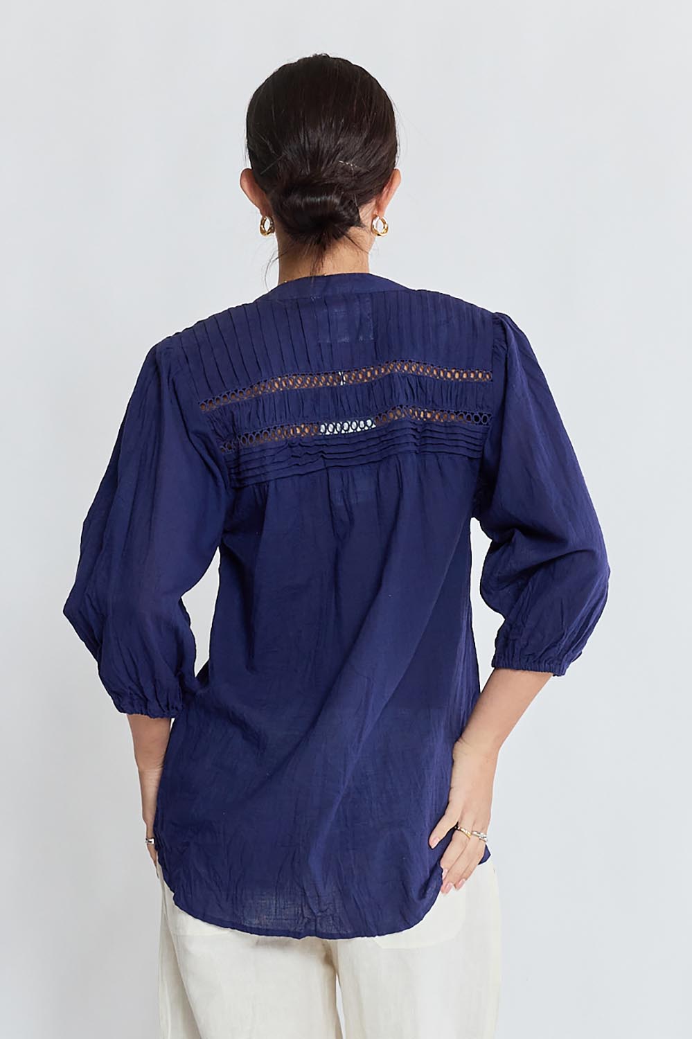 Model Genericm wearing size sample of the Laverne Tuck Shirt – Navy in colour Navy, from the back