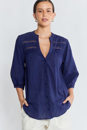 Model Genericm wearing size sample of the Laverne Tuck Shirt – Navy in colour Navy, in a cropped view