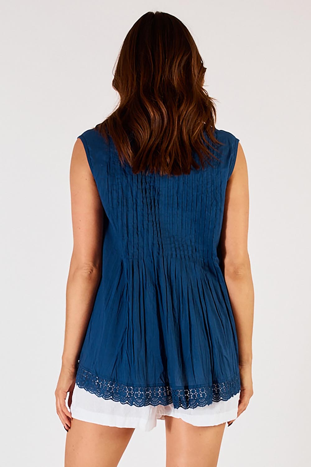 A model wearing the Leila Cotton Tank in colour Navy (Blue), from the back