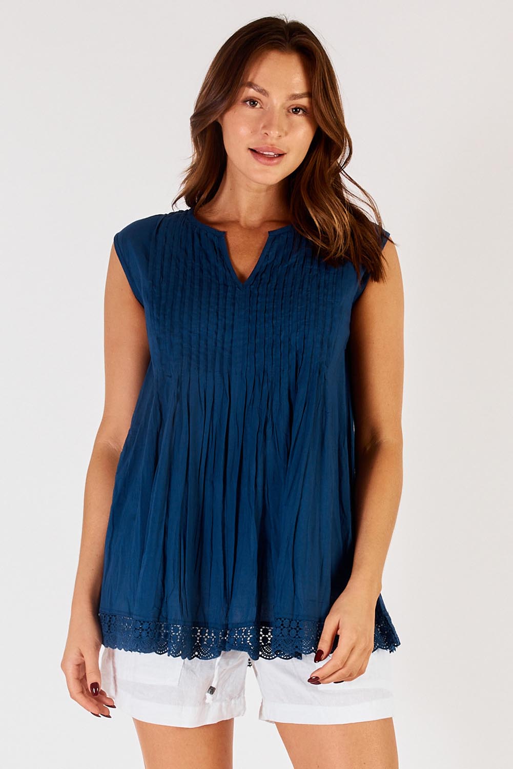 A model wearing the Leila Cotton Tank in colour Navy (Blue), from the front, cropped image