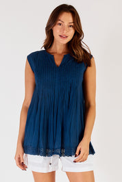 A model wearing the Leila Cotton Tank in colour Navy (Blue), from the front, cropped image