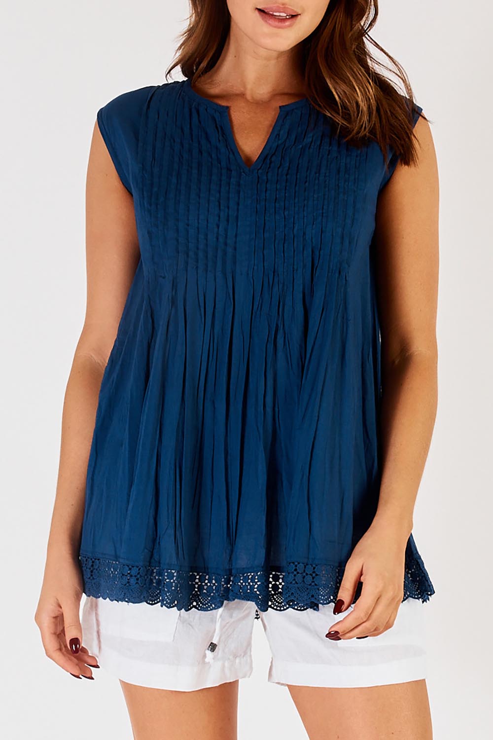 A model wearing the Leila Cotton Tank in colour Navy (Blue), from the front, cropped image