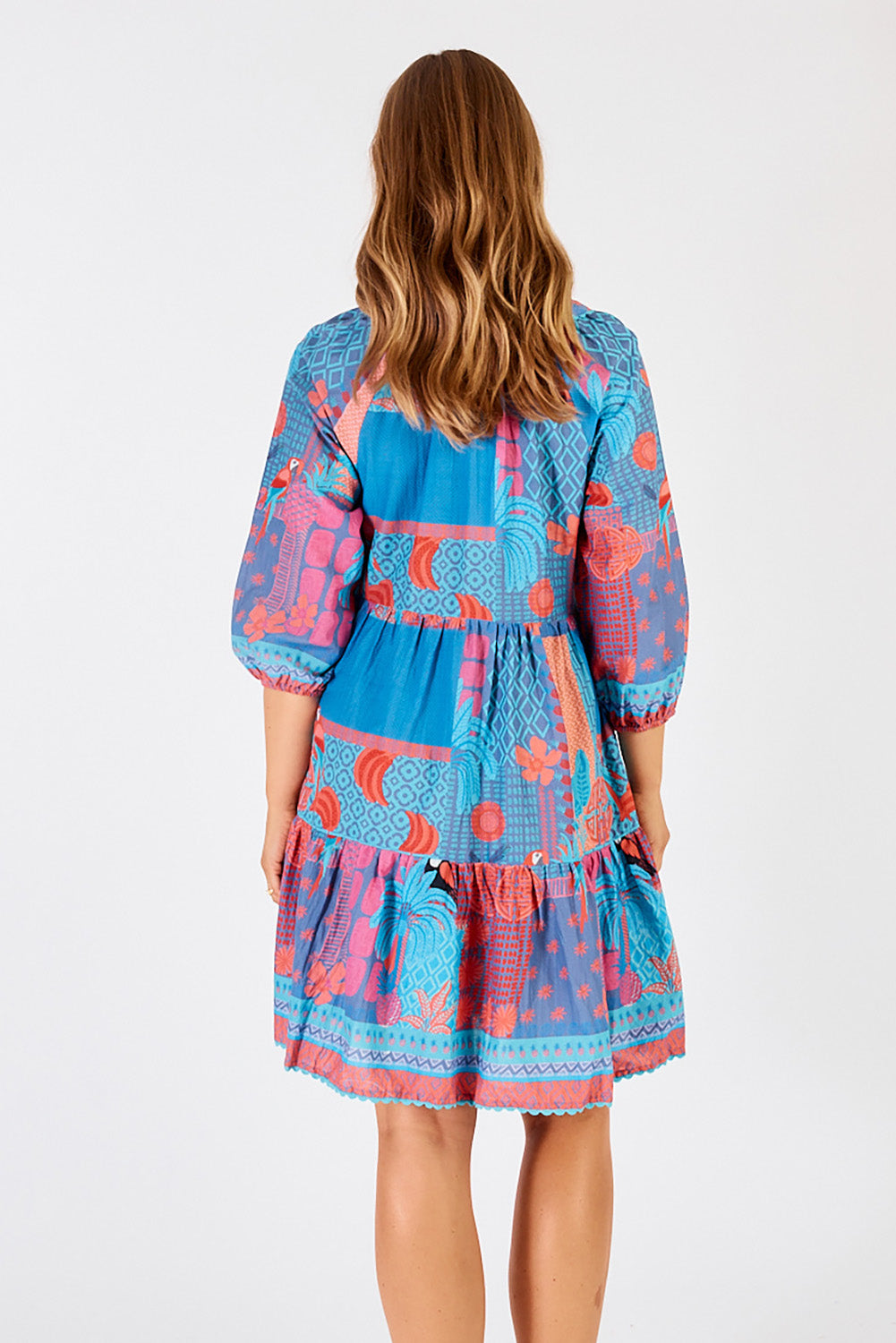 A model wearing the Luna Cotton Dress in colour Lagoon (Blue), from the back