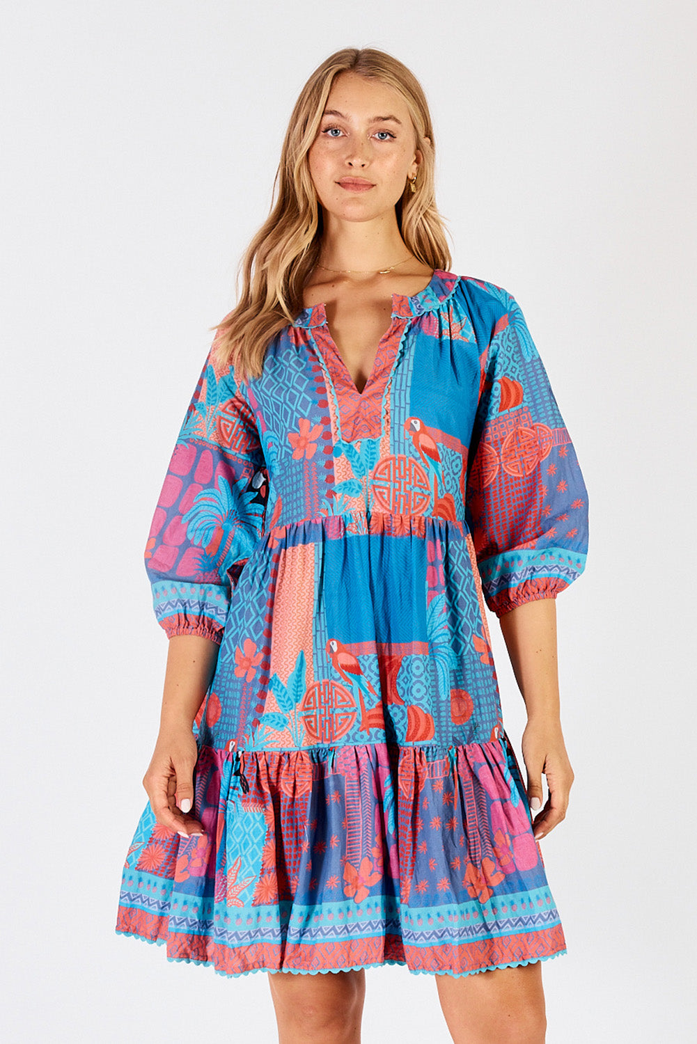 A model wearing the Luna Cotton Dress in colour Lagoon (Blue), from the front, cropped image