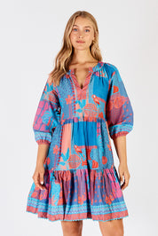 A model wearing the Luna Cotton Dress in colour Lagoon (Blue), from the front, cropped image