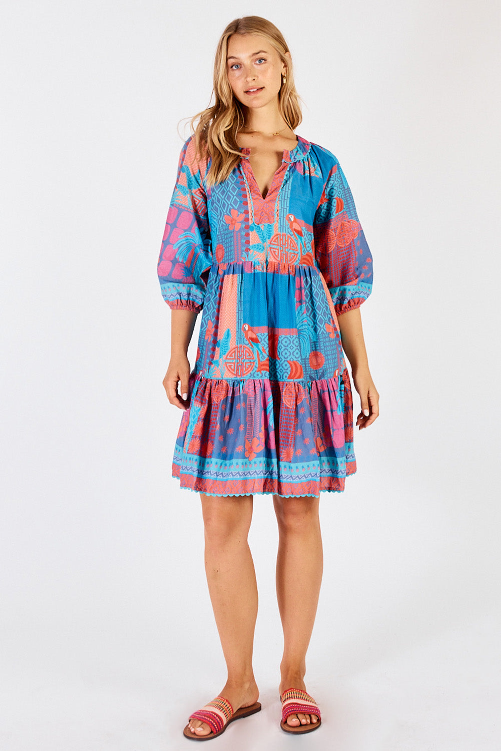 A model wearing the Luna Cotton Dress in colour Lagoon (Blue), from the front, showing the whole outfit