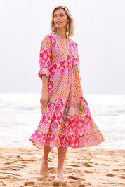 Model Phoebe wearing size S of the Maya Cotton Midi Dress in colour Melon (Pink), from the front, showing the whole outfit