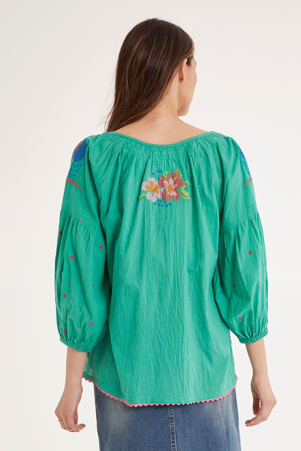 Model Madeline wearing size S of the Mermaid Top in colour Sea (Green), from the back