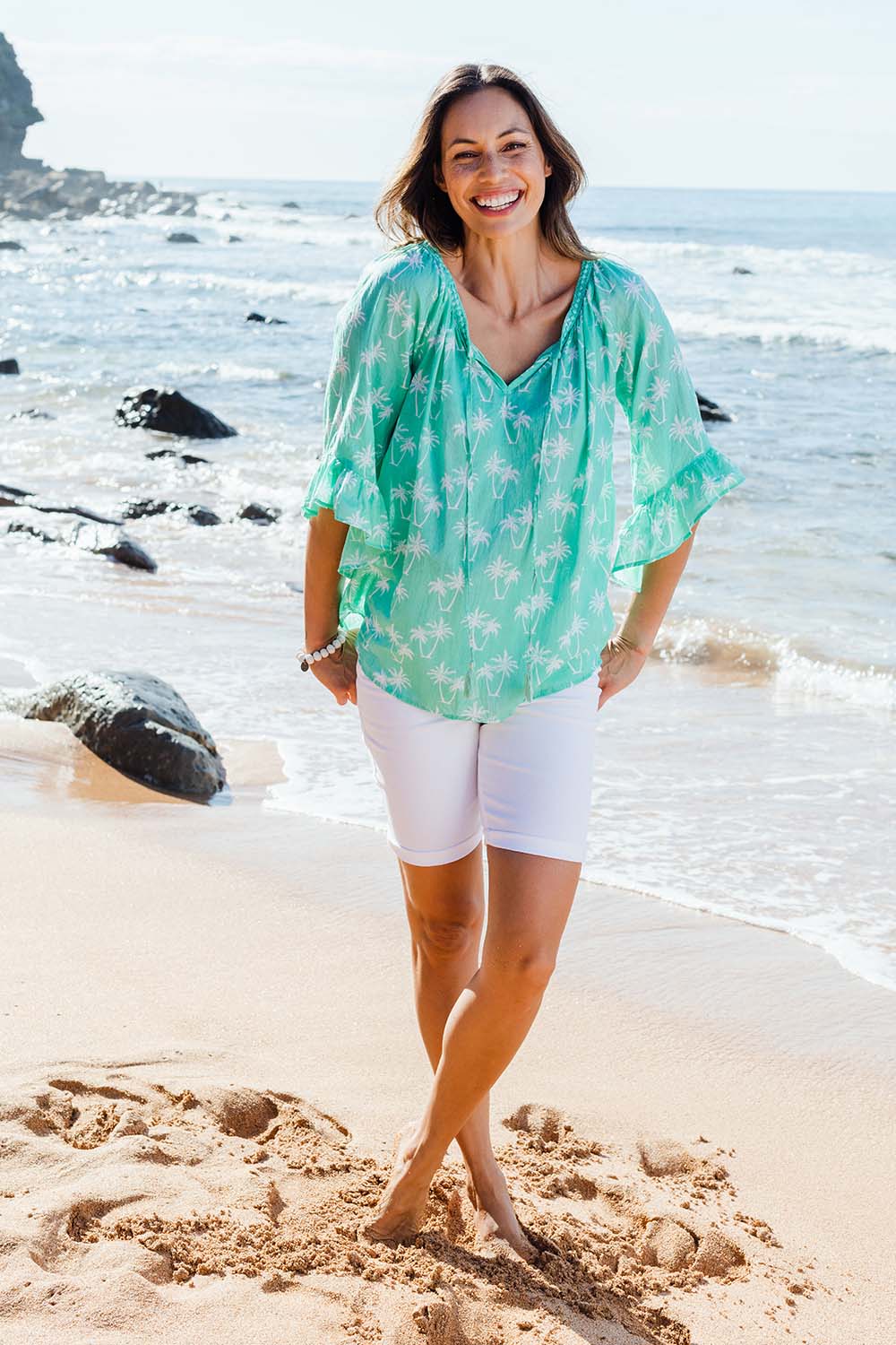 Model Amanda wearing size S of the Miami Top in colour Surf (Green), from the front, showing the whole outfit