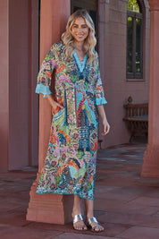 A model wearing the Mosaic Maxi Dress in colour Print (Blue), from the front, showing the whole outfit