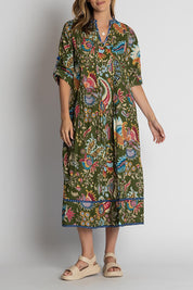 A model wearing the Nandita Cotton Midi Dress in colour Olive (Green), from the front, cropped image