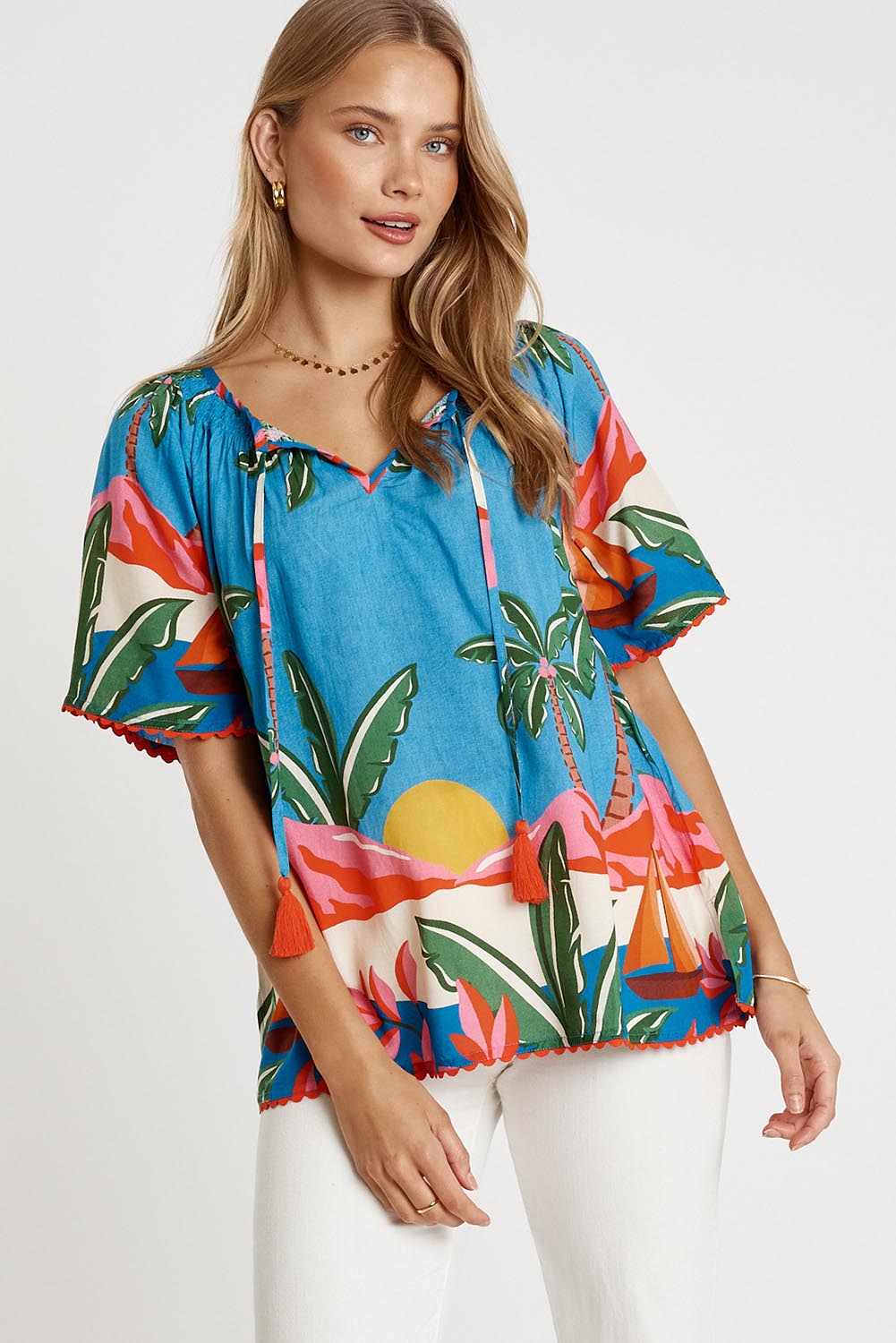 A model wearing the Pacifica Top in colour Print (Blue), from the front, cropped image