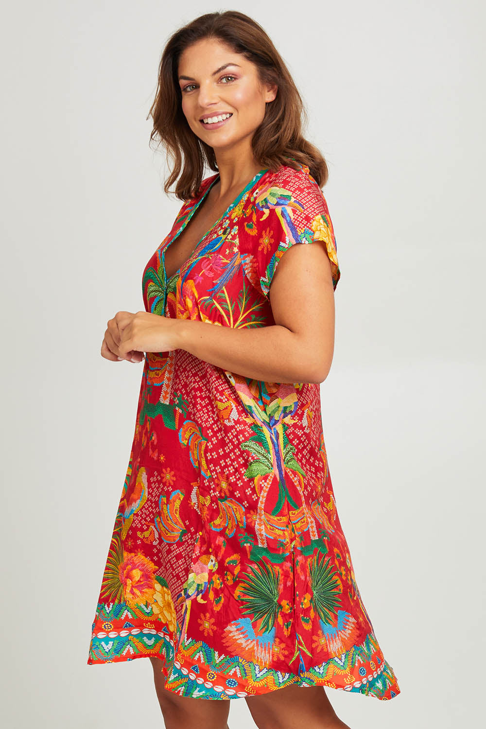 Model Monique wearing size L of the Peregian Dress in colour Melon (Red), from the front, cropped image