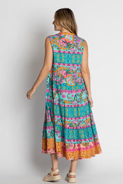 A model wearing the Ratana Cotton Midi Dress in colour Lagoon (Blue), from the back