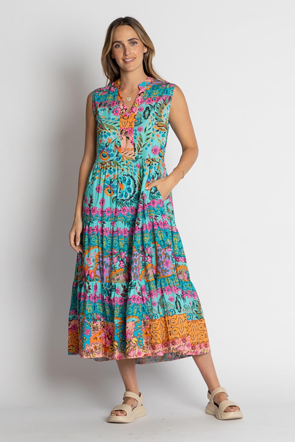 A model wearing the Ratana Cotton Midi Dress in colour Lagoon (Blue), from the front, showing the whole outfit