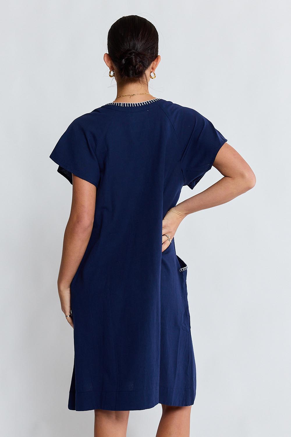 Model Genericm wearing size sample of the Remi Dress – Navy in colour Navy, from the back