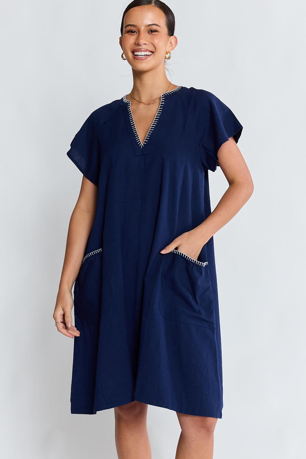 Model Genericm wearing size sample of the Remi Dress – Navy in colour Navy, in a cropped view