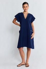 Model Genericm wearing size sample of the Remi Dress – Navy in colour Navy, from the front