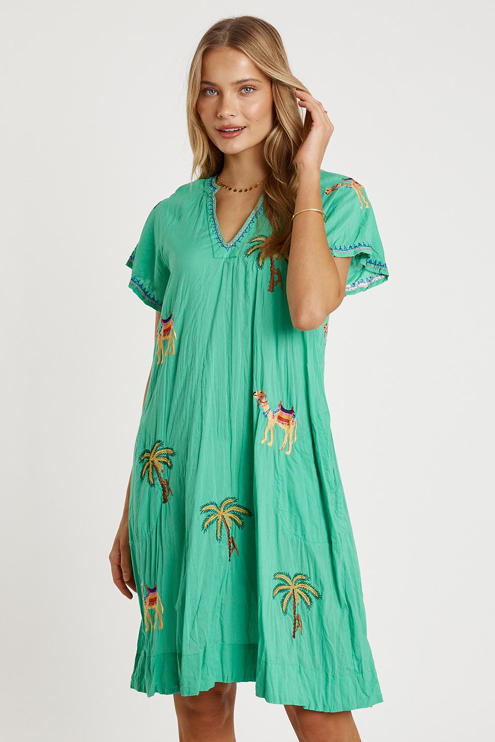 A model wearing the Sahara Cotton Dress in colour Sea (Green), from the front, cropped image