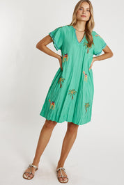 A model wearing the Sahara Cotton Dress in colour Sea (Green), from the front, showing the whole outfit
