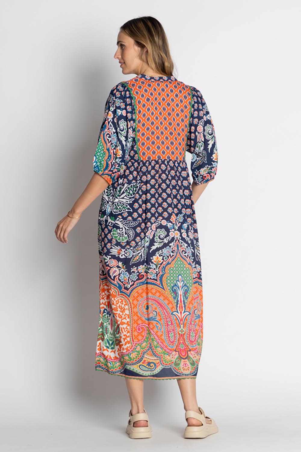 A model wearing the Sarah Midi Dress in colour Navy (Blue), from the back