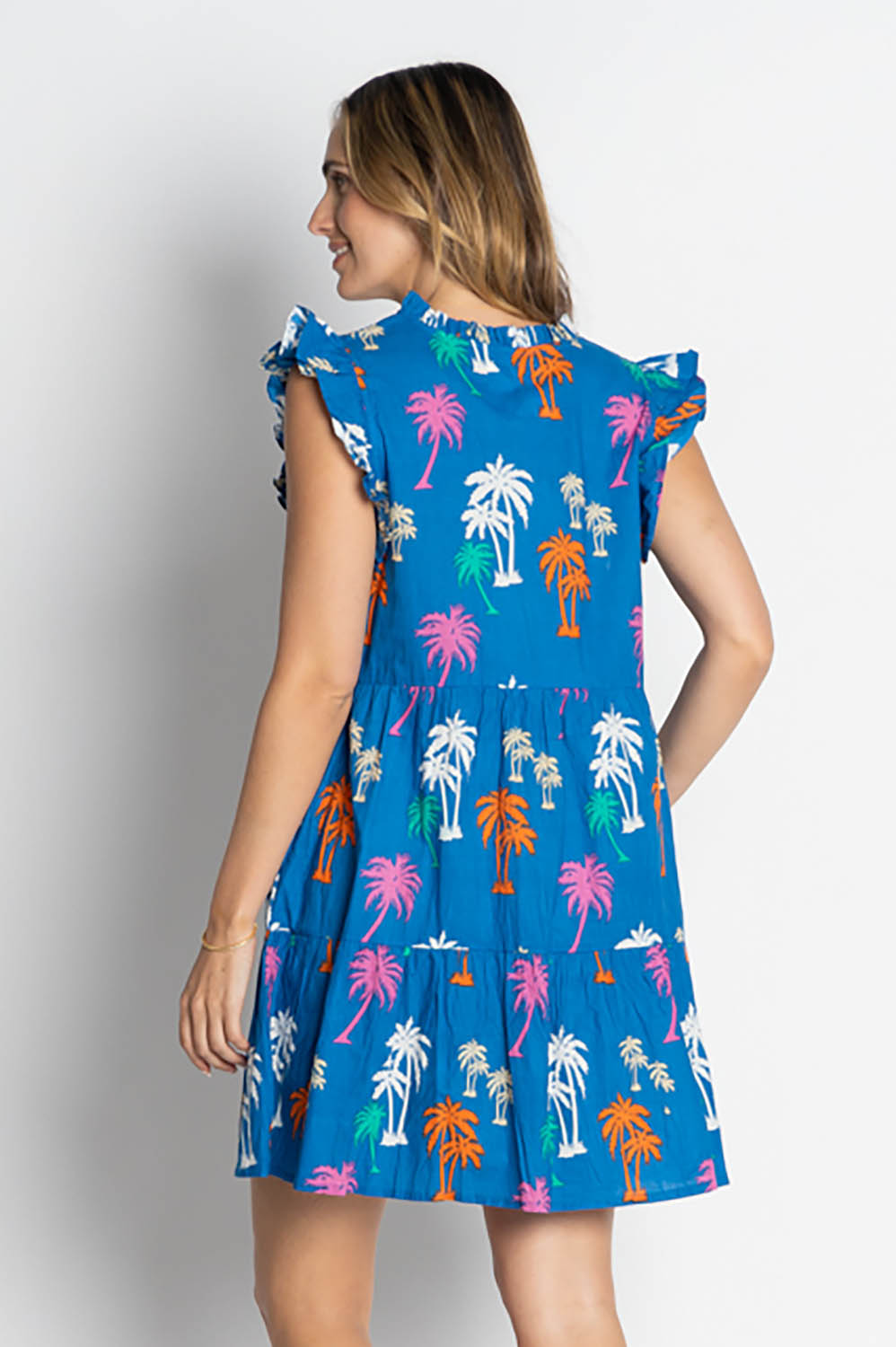 A model wearing the Shamira Cotton Dress in colour Navy (Blue), from the back