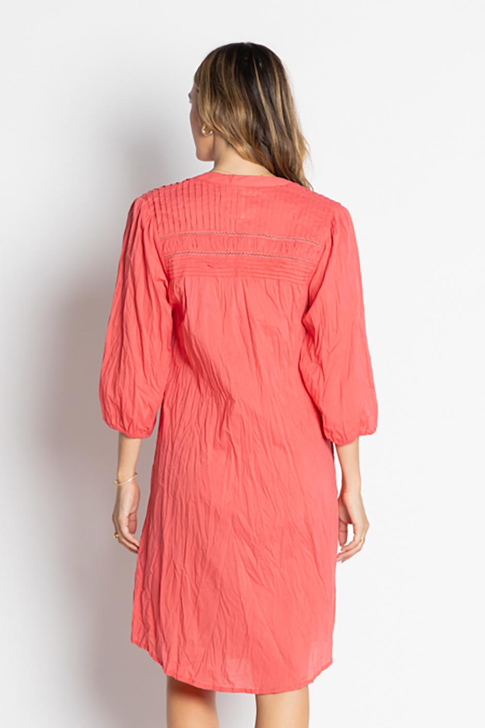 A model wearing the Shayna Cotton Button Dress in colour Geranium (Pink), from the back