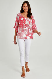 Model Madeline wearing size S of the Tahiti Top in colour Red (Red), from the front, showing the whole outfit