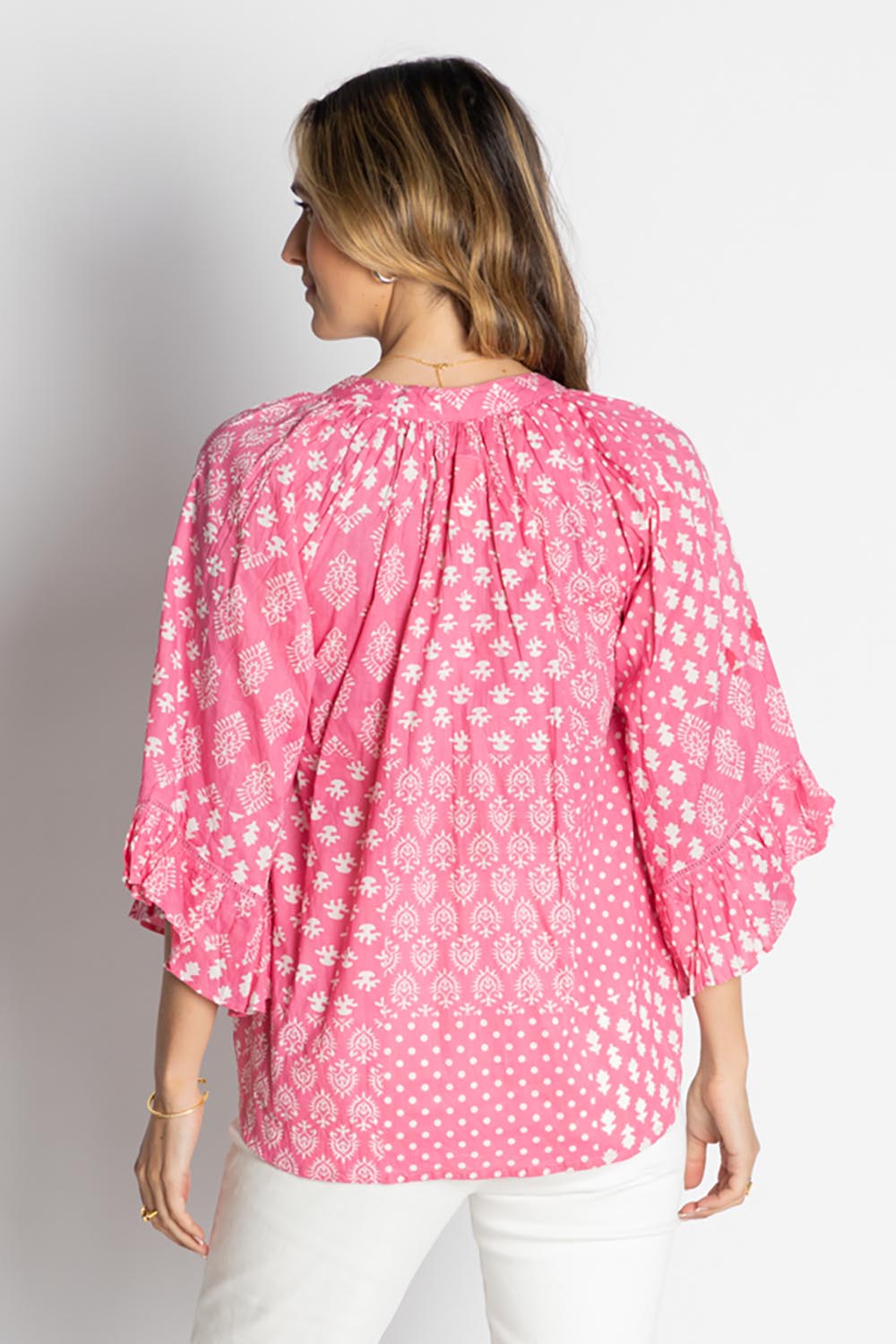 A model wearing the Talei Cotton Top in colour Musk (Pink), from the back
