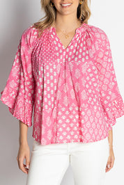 A model wearing the Talei Cotton Top in colour Musk (Pink), from the front, cropped image