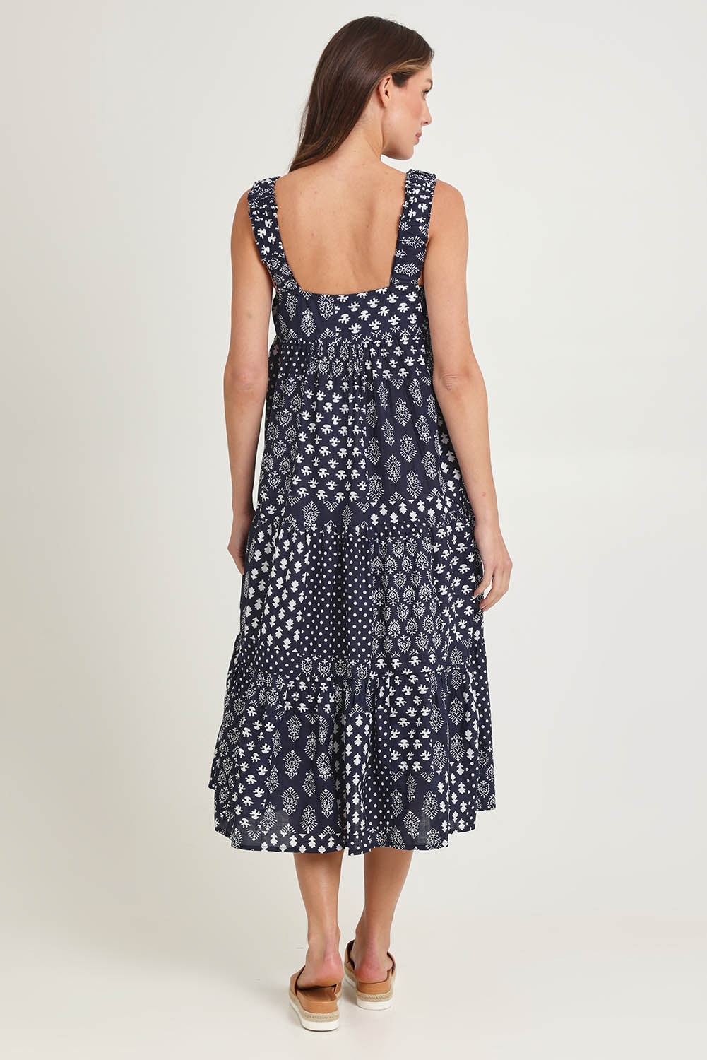 Model Madeline wearing size S of the Talei Cotton Sundress in colour Navy (Blue), from the back