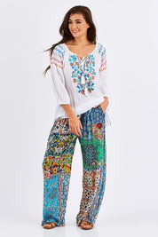 Model Chesska wearing size S of the Tangier Pant in colour Print (Blue), from the front, showing the whole outfit