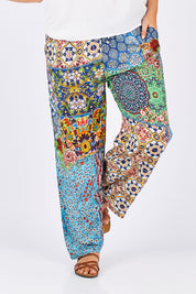 Model Jess wearing size L of the Tangier Pant in colour Print (Blue), from the front, cropped image