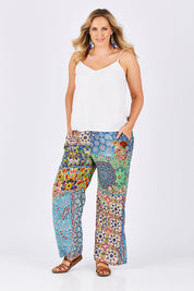 Model Jess wearing size L of the Tangier Pant in colour Print (Blue), from the front, showing the whole outfit
