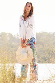 Model Riina wearing size S of the Tangier Pant in colour Print (Blue), from the front, showing the whole outfit