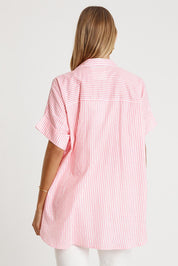 A model wearing the Tillie Cotton Shirt in colour Candy (Pink), from the back