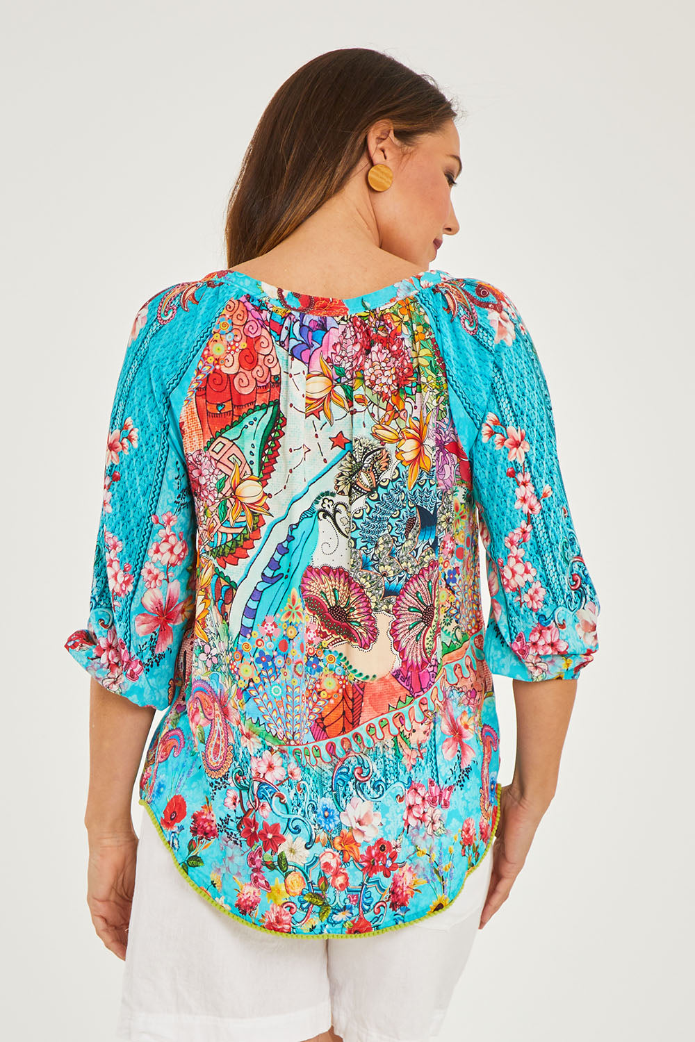Model Georgia wearing size S of the Tyra Top in colour Print (Blue), from the back