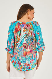 Model Georgia wearing size S of the Tyra Top in colour Print (Blue), from the back