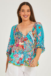 Model Georgia wearing size S of the Tyra Top in colour Print (Blue), from the front, cropped image