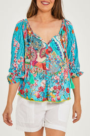 Model Georgia wearing size S of the Tyra Top in colour Print (Blue), from the front, cropped image