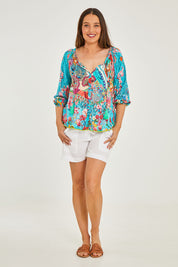 Model Georgia wearing size S of the Tyra Top in colour Print (Blue), from the front, showing the whole outfit