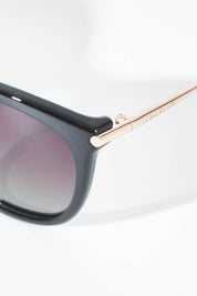 A model wearing size OneSize of the Ashley Sunglasses in colour Black (Black), from the front, showing the whole outfit