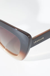 A model wearing size OneSize of the Eden Sunglasses in colour Ombrebrown, from the front, showing the whole outfit