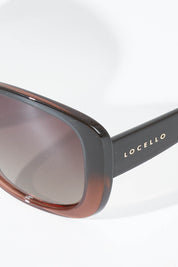 A model wearing size OneSize of the Franca Sunglasses in colour Brown, from the front, showing the whole outfit