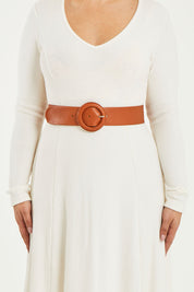 A model wearing size S of the Skye Wide Leather Waist Belt in colour Tan, from the front, cropped image