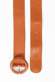 A model wearing size S of the Skye Wide Leather Waist Belt in colour Tan, from the front, showing the whole outfit